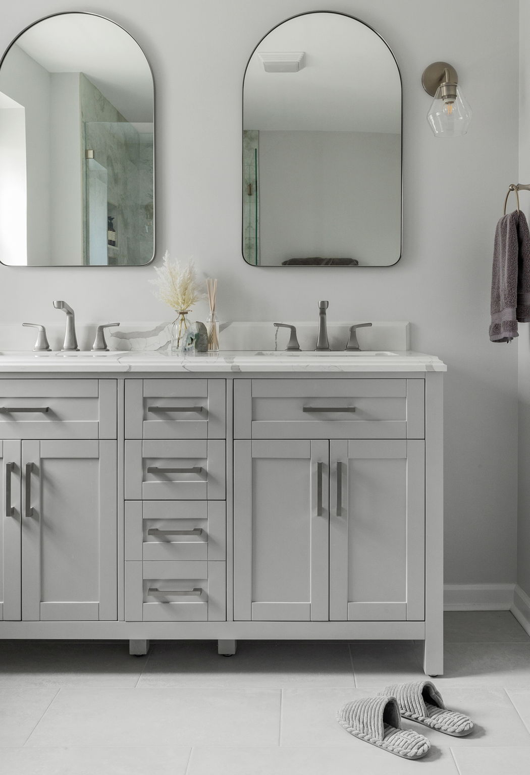 Double vanity with gray shaker cabinets and stone countertops in Delaware bathroom remodel